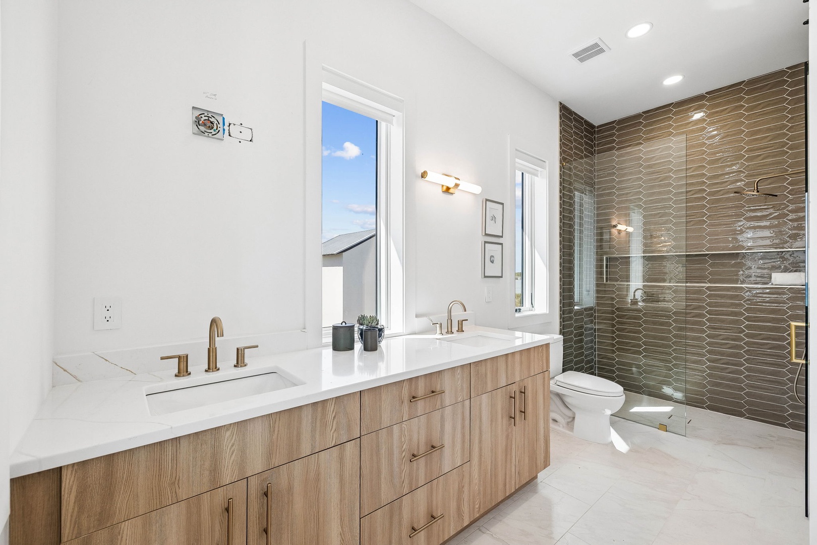 Refresh in your sleek spa-inspired bathroom with dual vanities, a rainfall shower, and thoughtful modern touches that make your morning routine feel like a luxury retreat.