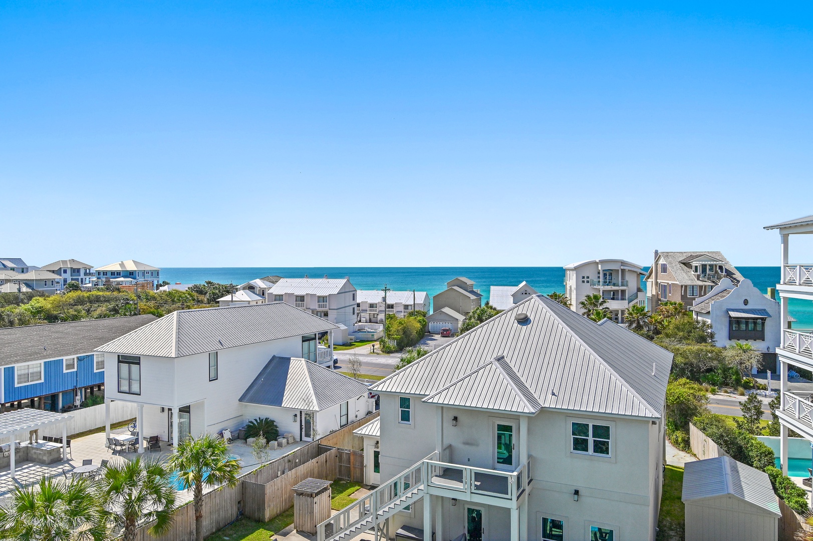 Coastal community featuring beach homes and lush landscaping with direct ocean access just beyond the neighborhood dunes.