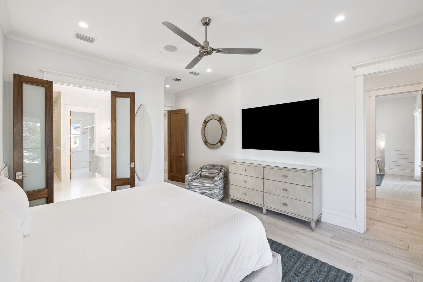 Your spacious bedroom features a ceiling fan and large TV for ultimate comfort after exploring the area.