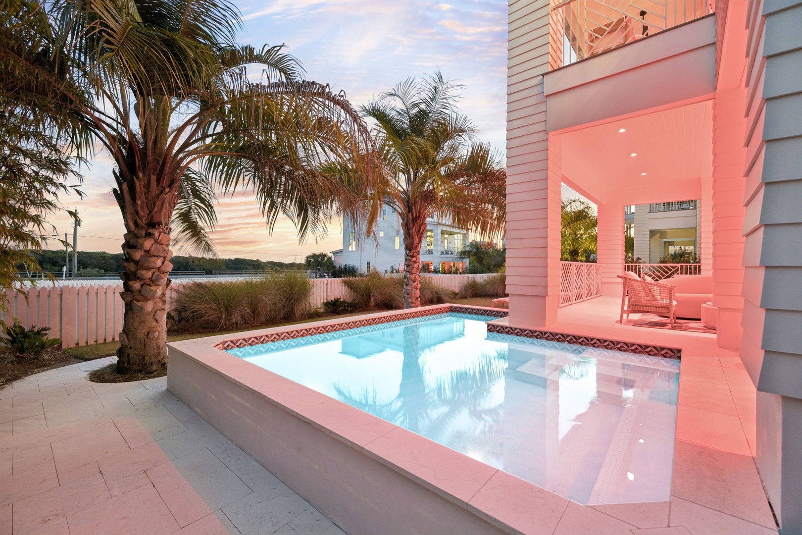 Dive into your private paradise with this stunning pool surrounded by tropical palms and elegant architecture.