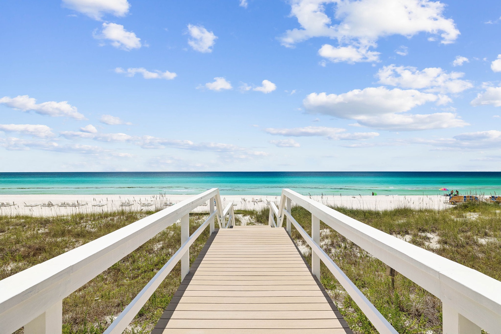 A private wooden boardwalk leads directly to pristine white sand and stunning turquoise waters, placing paradise just steps away from your door.