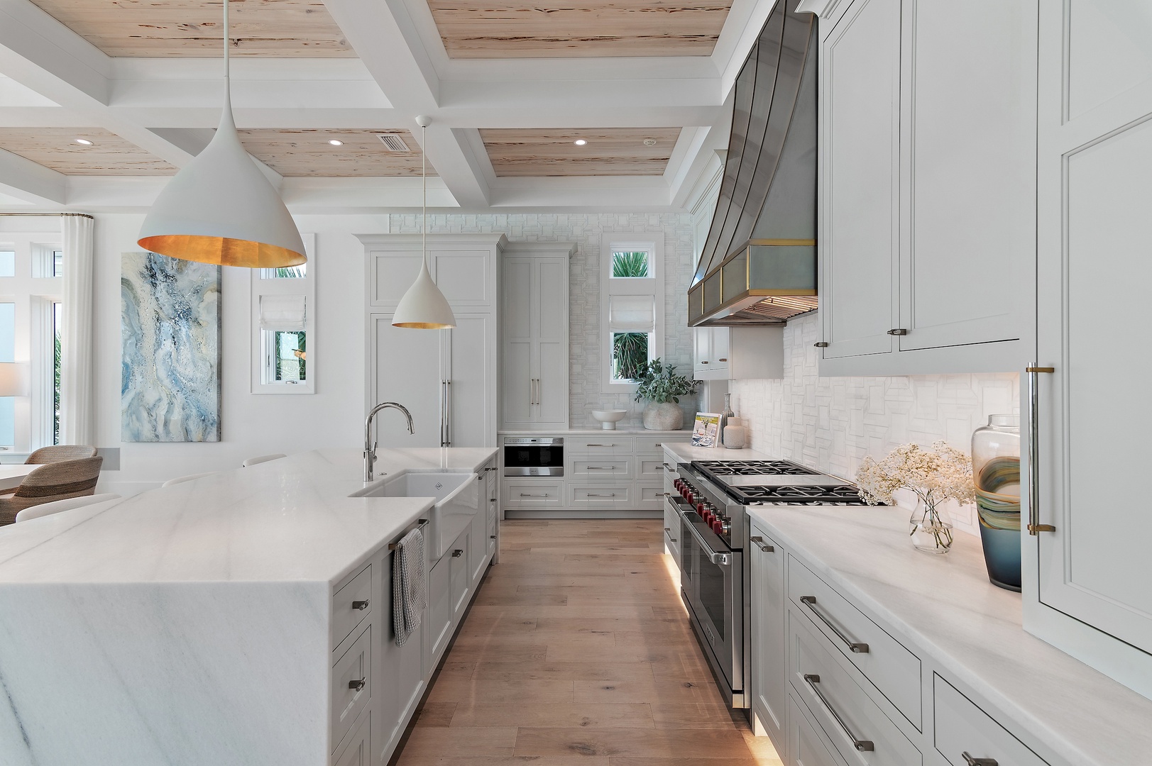 Cook your favorite meals in this elegant, fully-equipped chef's kitchen with marble countertops, professional-grade appliances, and warm coastal details throughout.