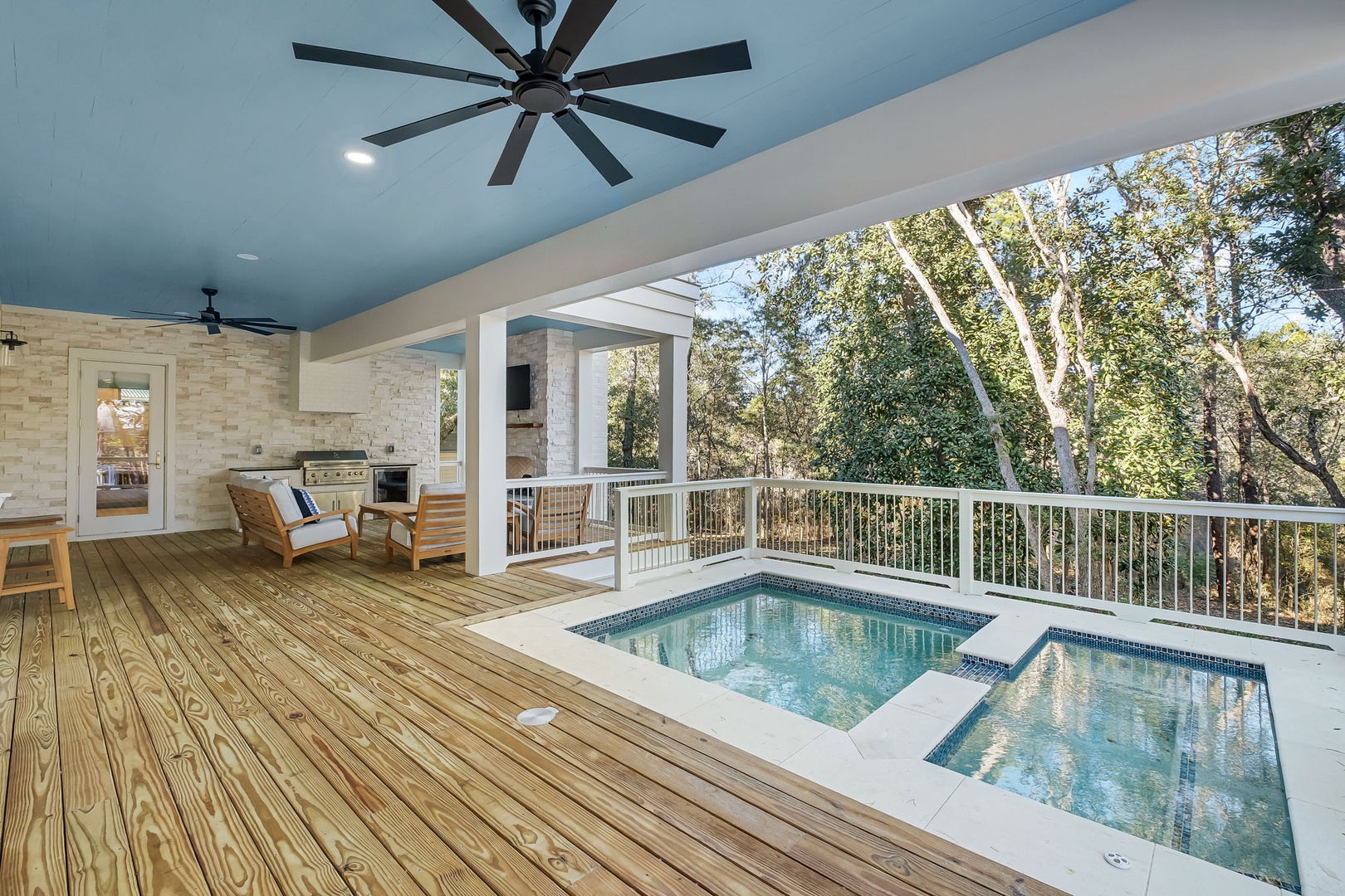 Relax on your private covered deck with pool and hot tub, surrounded by peaceful treetop views.