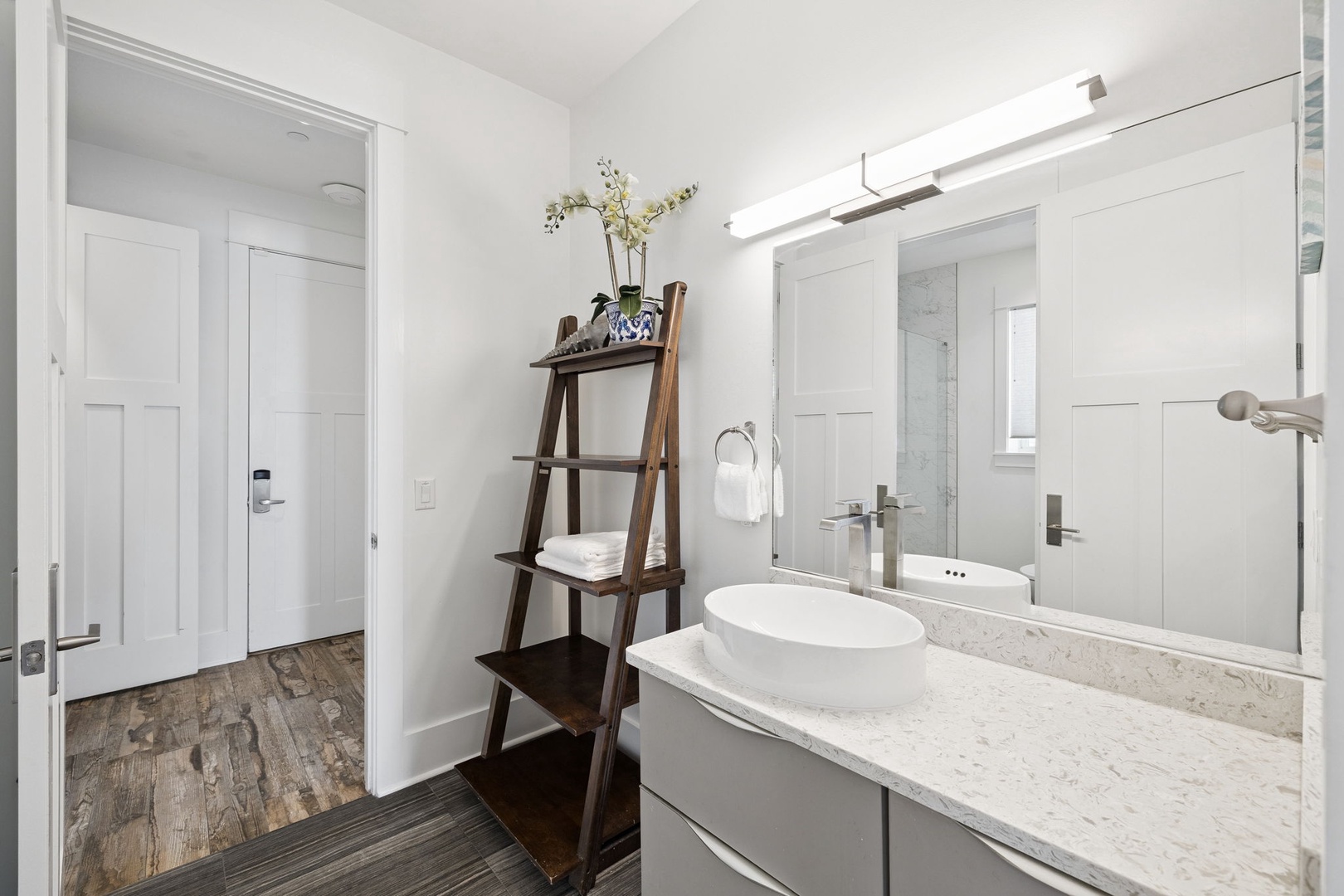 Step into your stylish bathroom featuring marble countertops, modern fixtures, and thoughtful storage for your comfort.