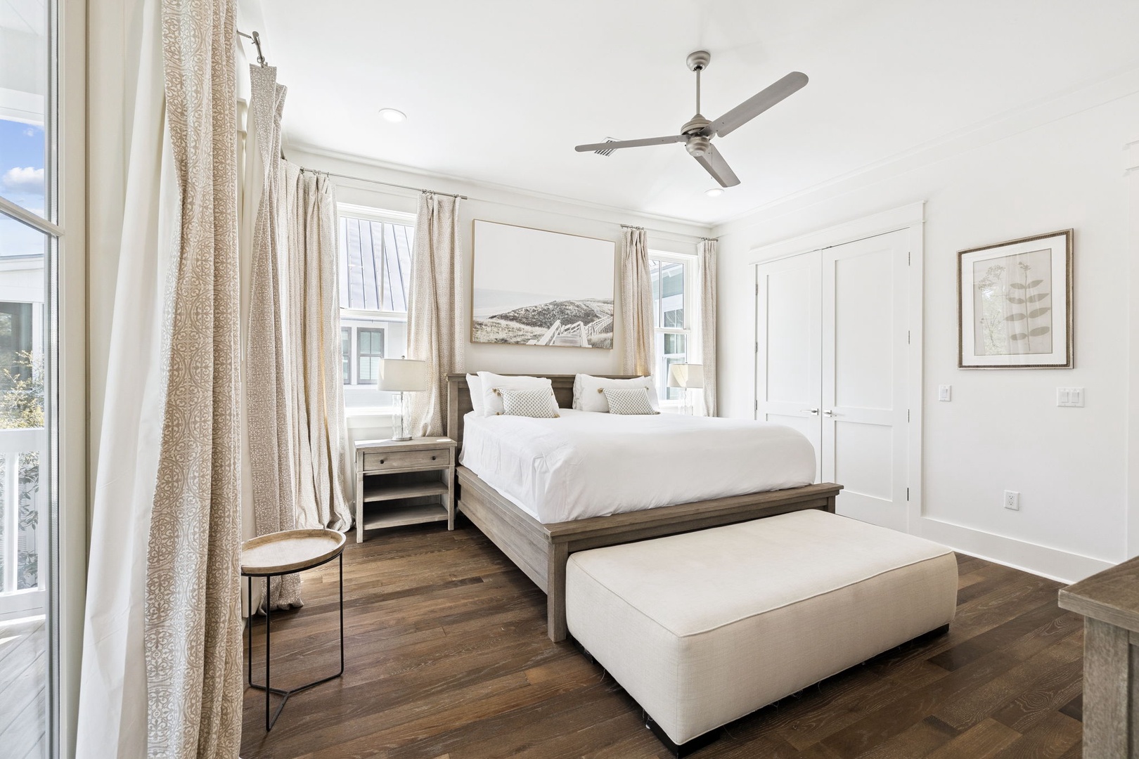 Unwind in your serene bedroom sanctuary with crisp linens, warm wood floors, and a gentle ceiling fan for peaceful nights.