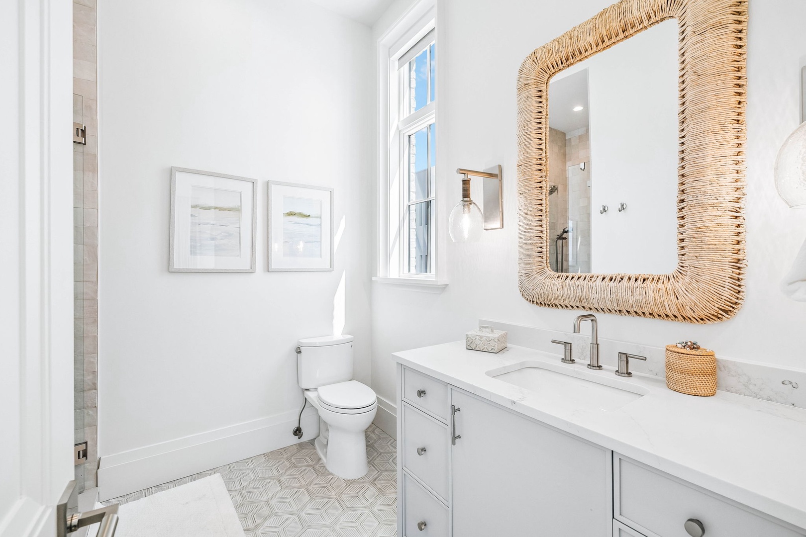 Step into your bright coastal oasis featuring a chic vanity and natural textures that create a serene, beachy vibe perfect for relaxing after a sun-soaked day.