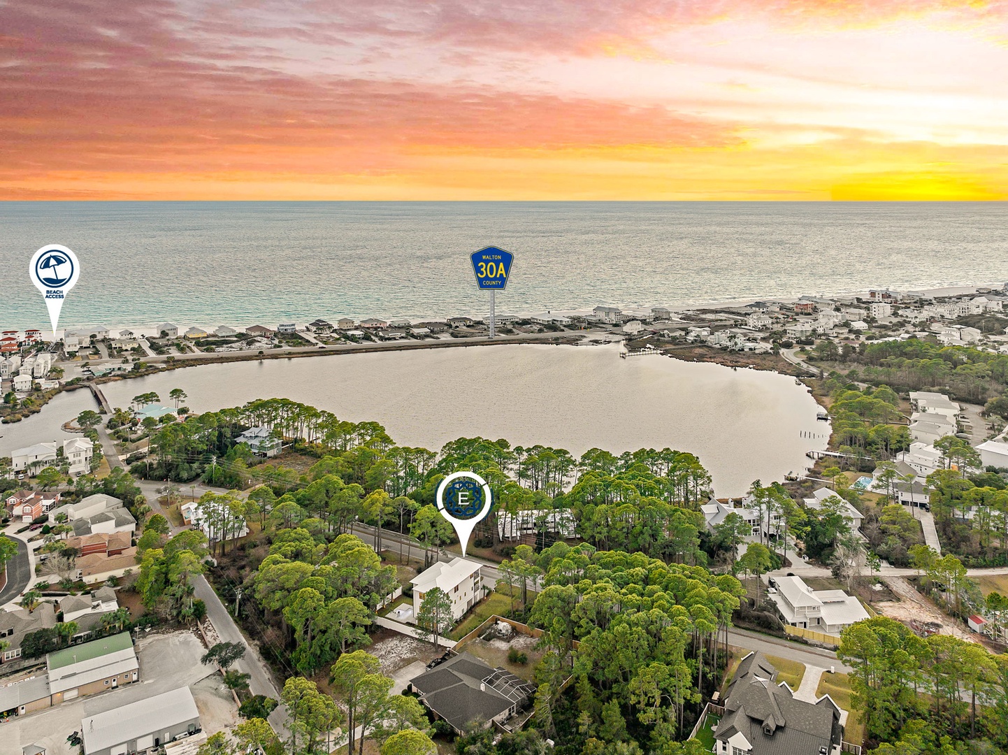 Stunning aerial view of the coastal community showcasing proximity to pristine beaches and scenic waterways at sunset.