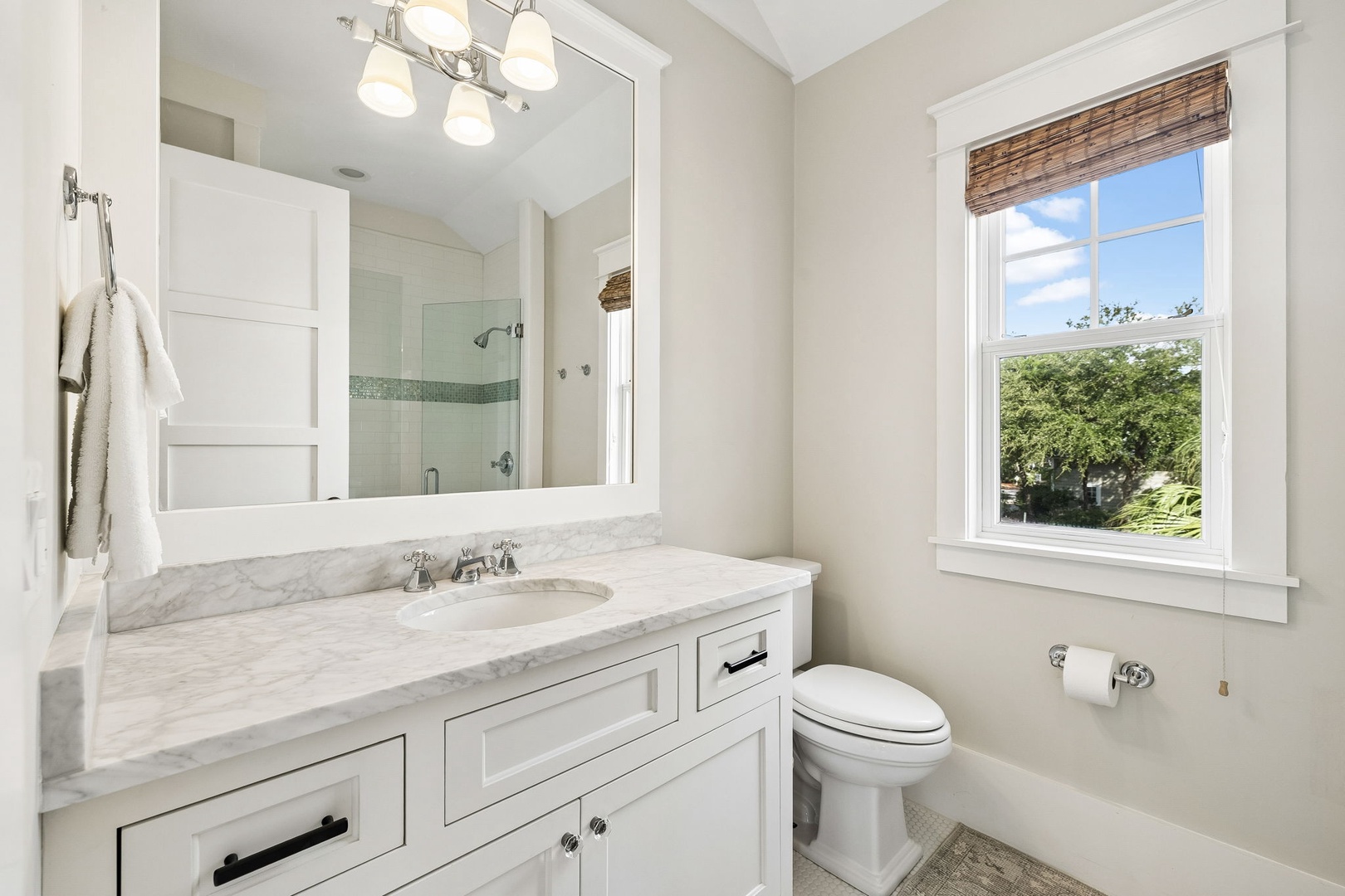 Unwind in your private bathroom, where soft natural light, marble countertops, and a walk-in shower create a bright and calming retreat for your mornings and evenings.