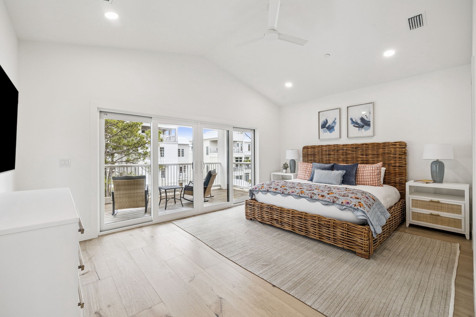 Wake up in this bright, airy bedroom featuring a stunning wicker bed and private balcony where you can sip morning coffee overlooking the charming neighborhood.