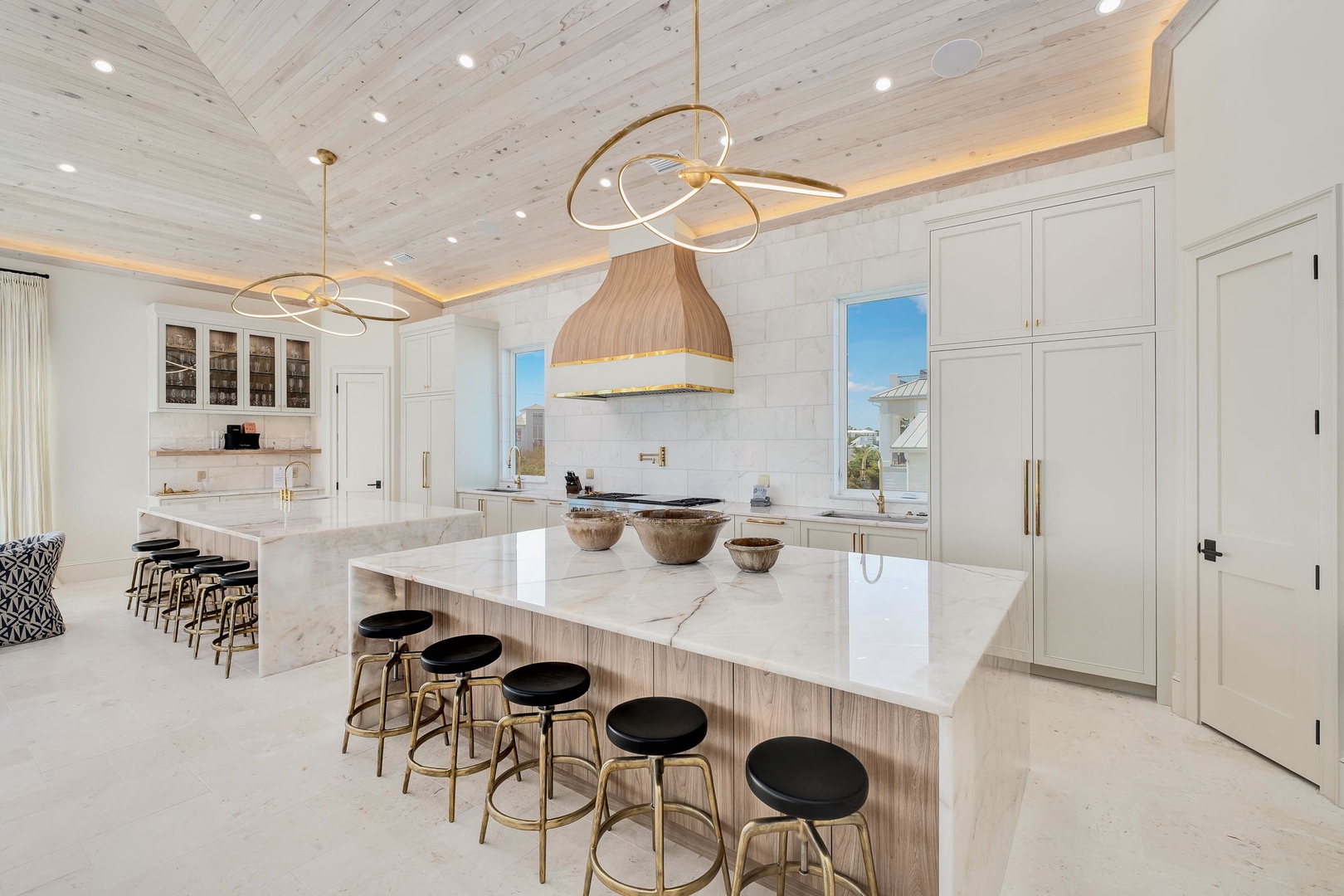 Gather around this stunning kitchen where marble counters and designer lighting create your dream cooking and entertaining space. Elegant details meet comfort in every corner.