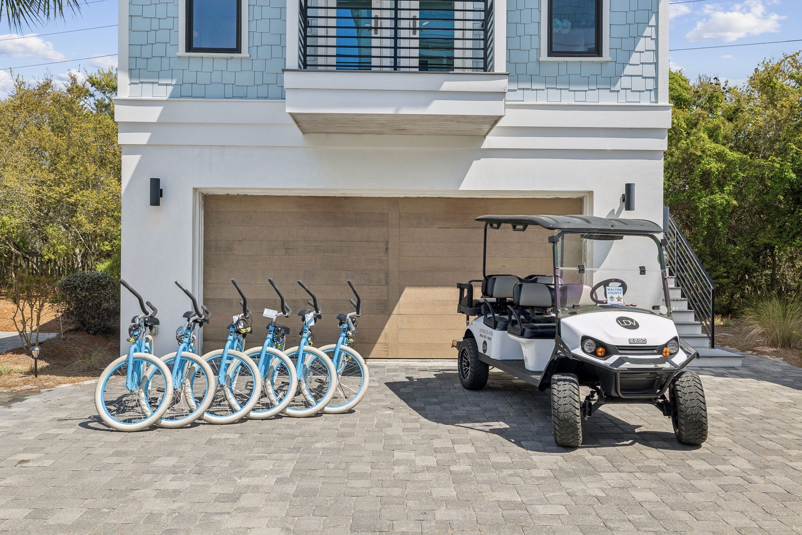 Modern vacation rental with bicycles and golf cart for exploring the area at your own pace.