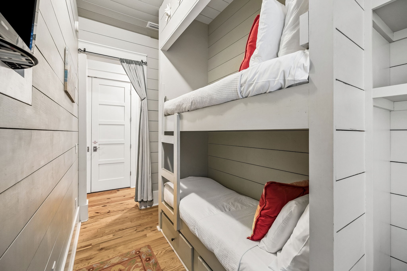 This cozy bunk room offers you the perfect spot for a good night's rest after a day of adventure. The crisp white linens and warm wood tones create a comfortable, welcoming retreat.