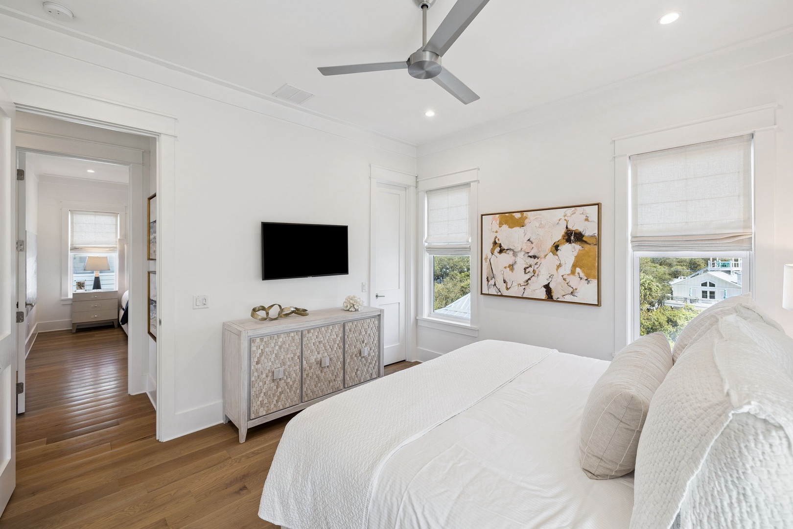 Unwind in your serene bedroom with crisp linens, modern amenities, and calming views through bright windows.