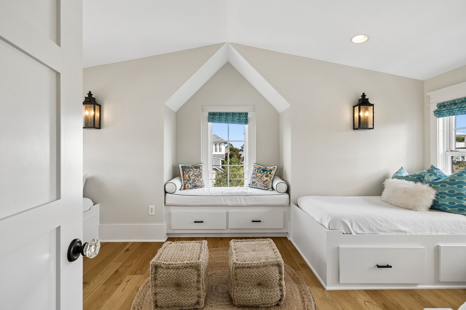 Curl up with a good book in your cozy built-in window nook, or stretch out on plush twin beds beneath vaulted ceilings. Natural light and cheerful coastal touches make this space perfect for rest.
