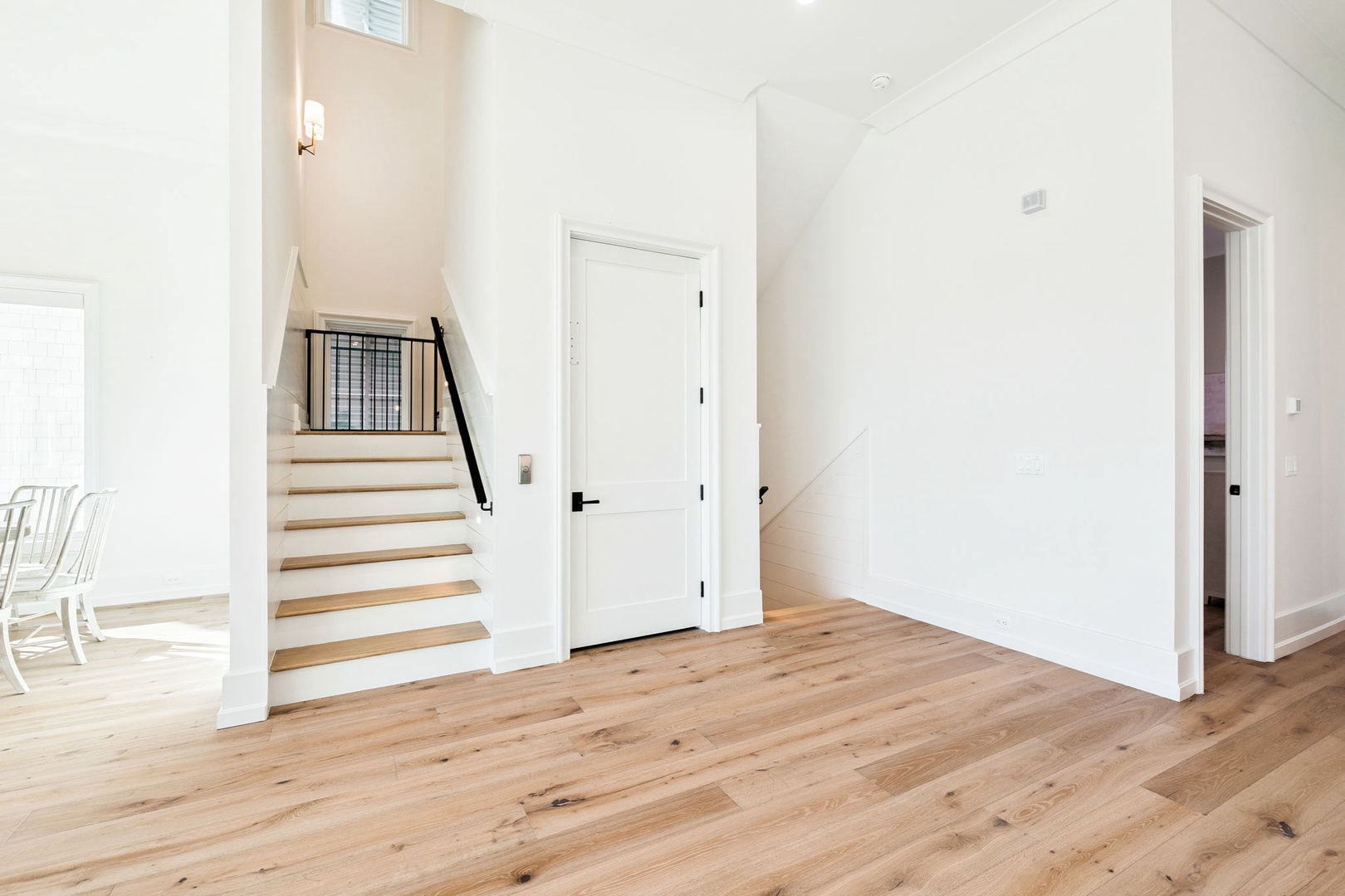 Step into your bright, modern entryway with gleaming hardwood floors and soaring ceilings that create an instant sense of spacious elegance.