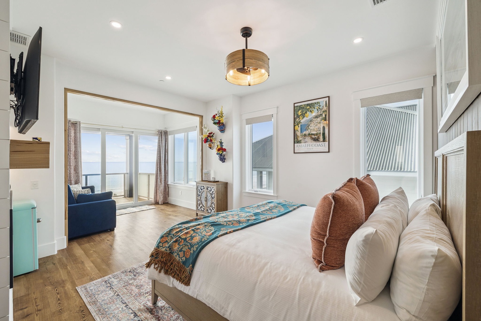 Unwind in your bright, stylish bedroom featuring plush bedding and a cozy seating nook where you can savor morning coffee.