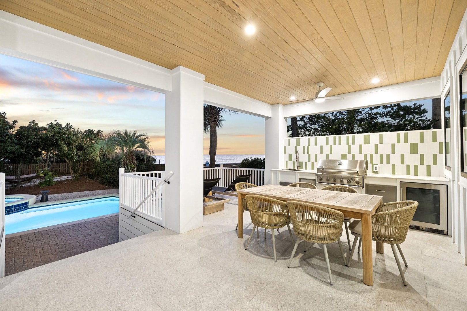 Your covered patio offers the perfect spot for al fresco dining with pool views and stunning sunset skies.