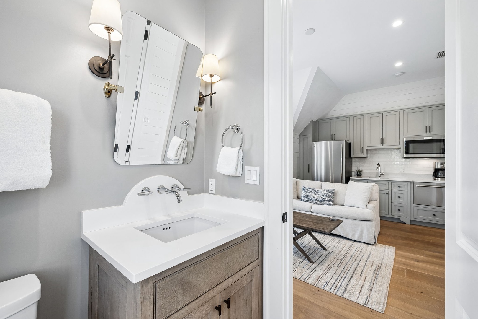 Unwind in your private bathroom with elegant fixtures and plush towels, just steps from the cozy living area with a fully equipped kitchen at your fingertips.