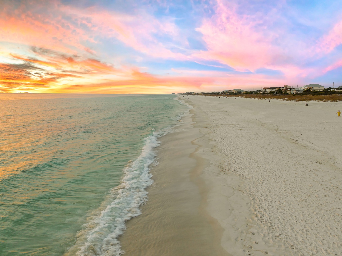 Stunning beachfront location with pristine white sand and turquoise waters, just steps from coastal homes.