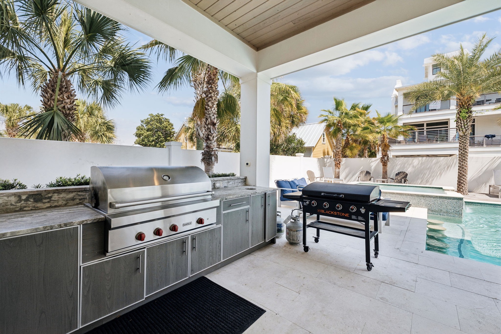Fire up the grill in your private outdoor kitchen with professional-grade equipment overlooking the sparkling pool.