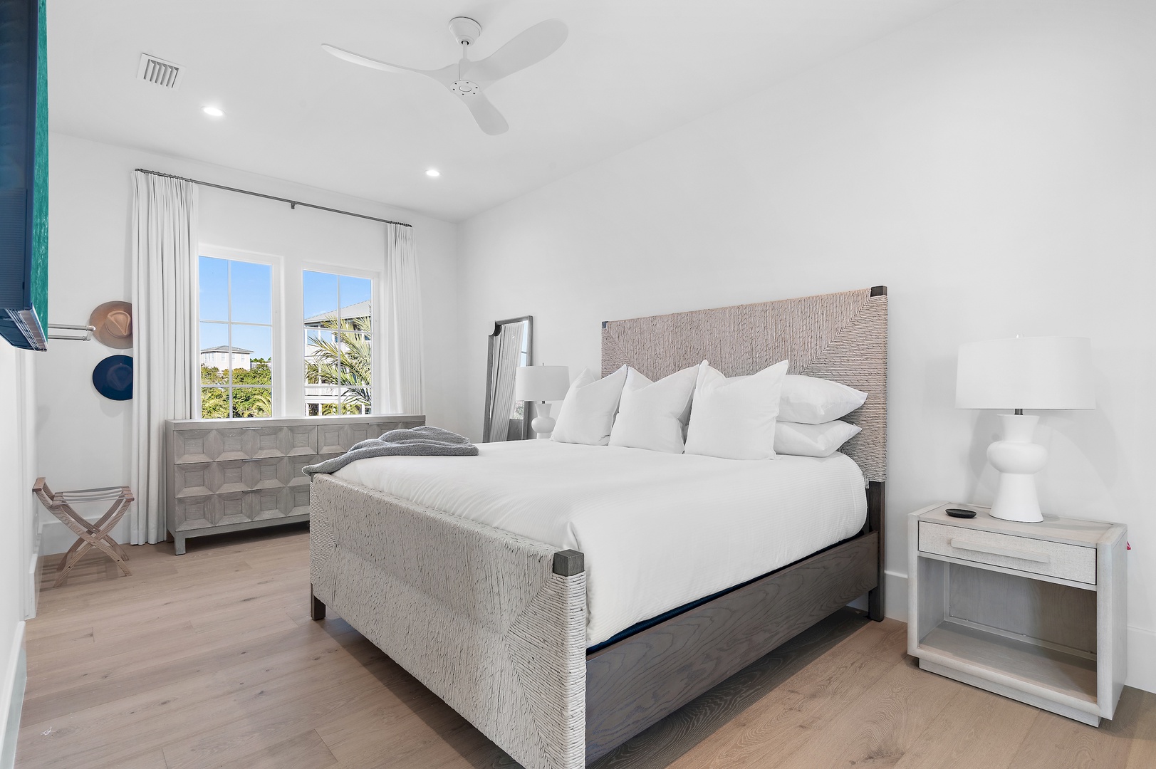 Unwind in your serene bedroom sanctuary, where plush bedding, coastal breezes, and soft lighting create the perfect peaceful retreat for your getaway.