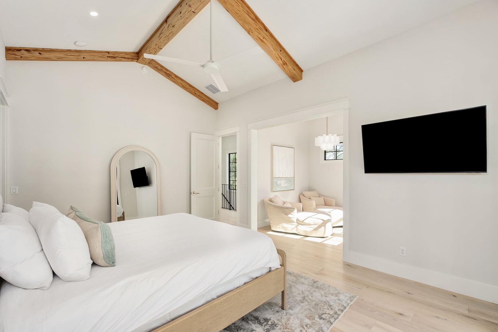 Drift off beneath soaring cathedral ceilings and rustic beams in this serene retreat, where your private sitting nook awaits morning coffee.