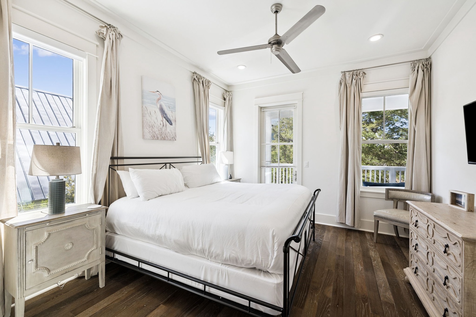 Drift off in your bright, airy bedroom with crisp linens and soothing coastal views through multiple windows.