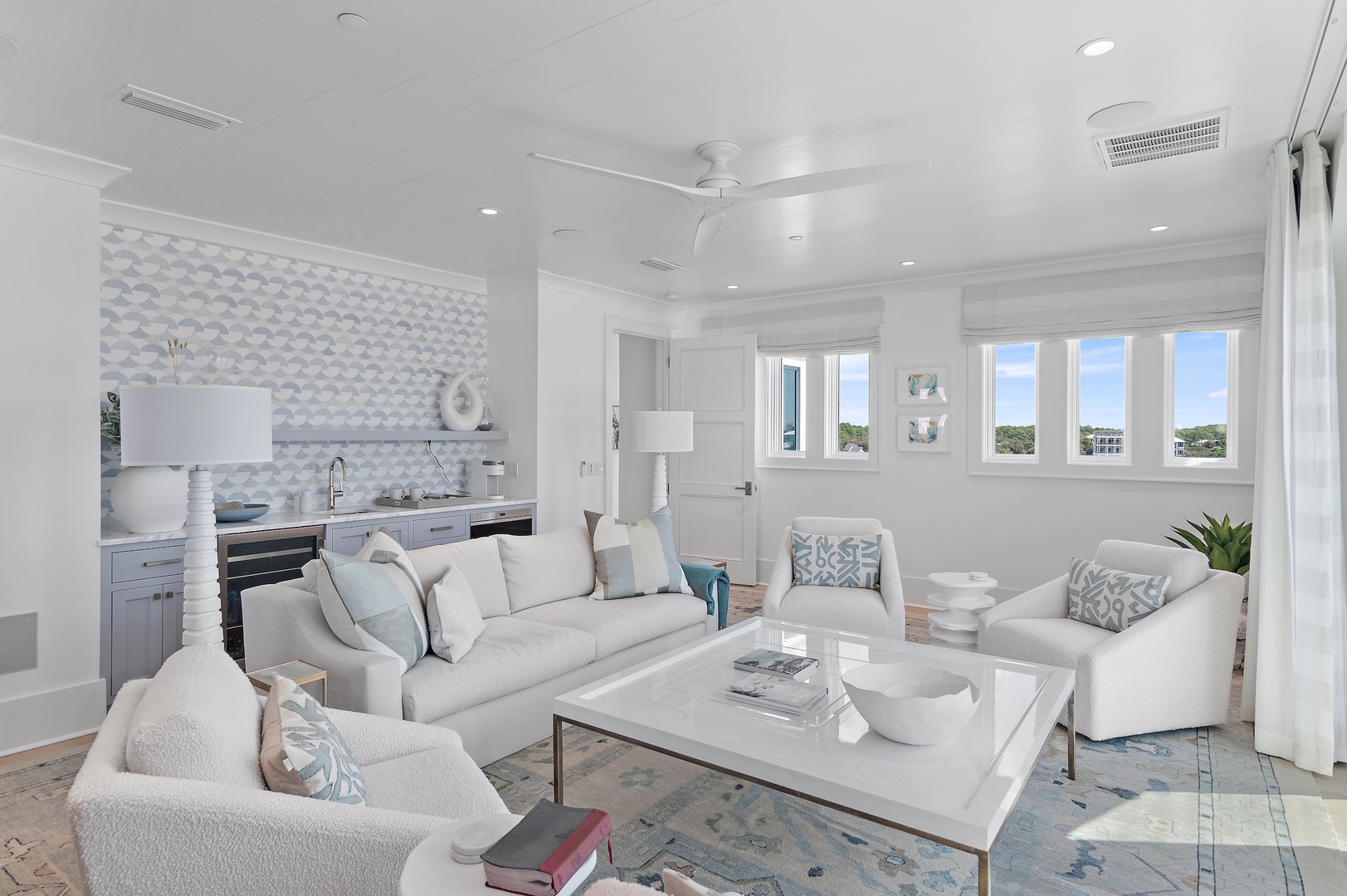 Sink into plush seating and soak in natural light streaming through your windows. This airy living space blends coastal elegance with comfort, perfect for unwinding after a day of exploration.