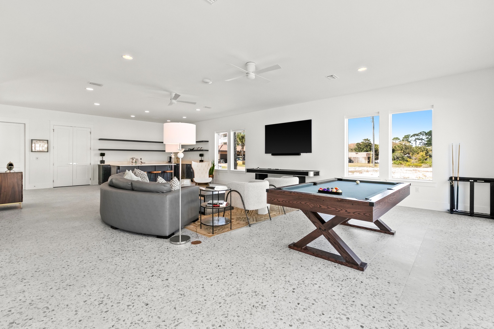 Challenge your crew to a game of pool in this bright, airy recreation room. You'll love the natural light streaming through large windows and the open layout perfect for unwinding together.