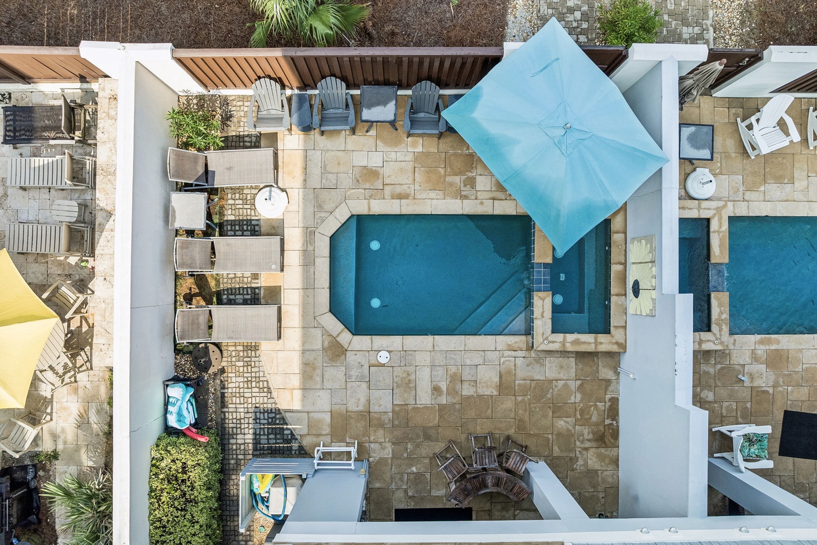 This property features beautifully designed outdoor spaces with multiple pools, sun-drenched patios, and lush tropical landscaping creating a resort-style retreat.