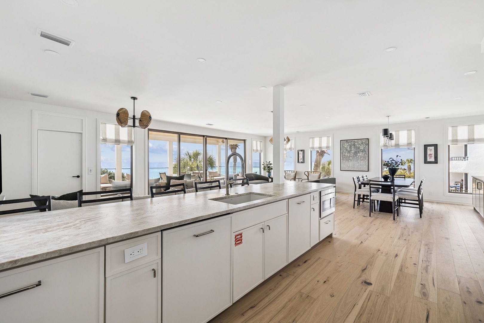 Cook with ocean views from your spacious kitchen island, where modern amenities meet stunning sea vistas through floor-to-ceiling windows.