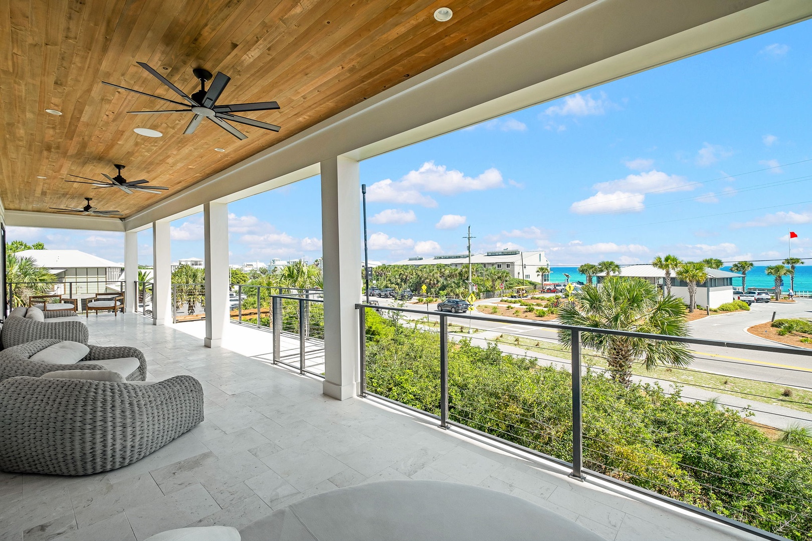 Unwind in your spacious covered terrace with stunning ocean views, ceiling fans, and cozy lounge seating—perfect for sipping morning coffee or enjoying warm coastal breezes.