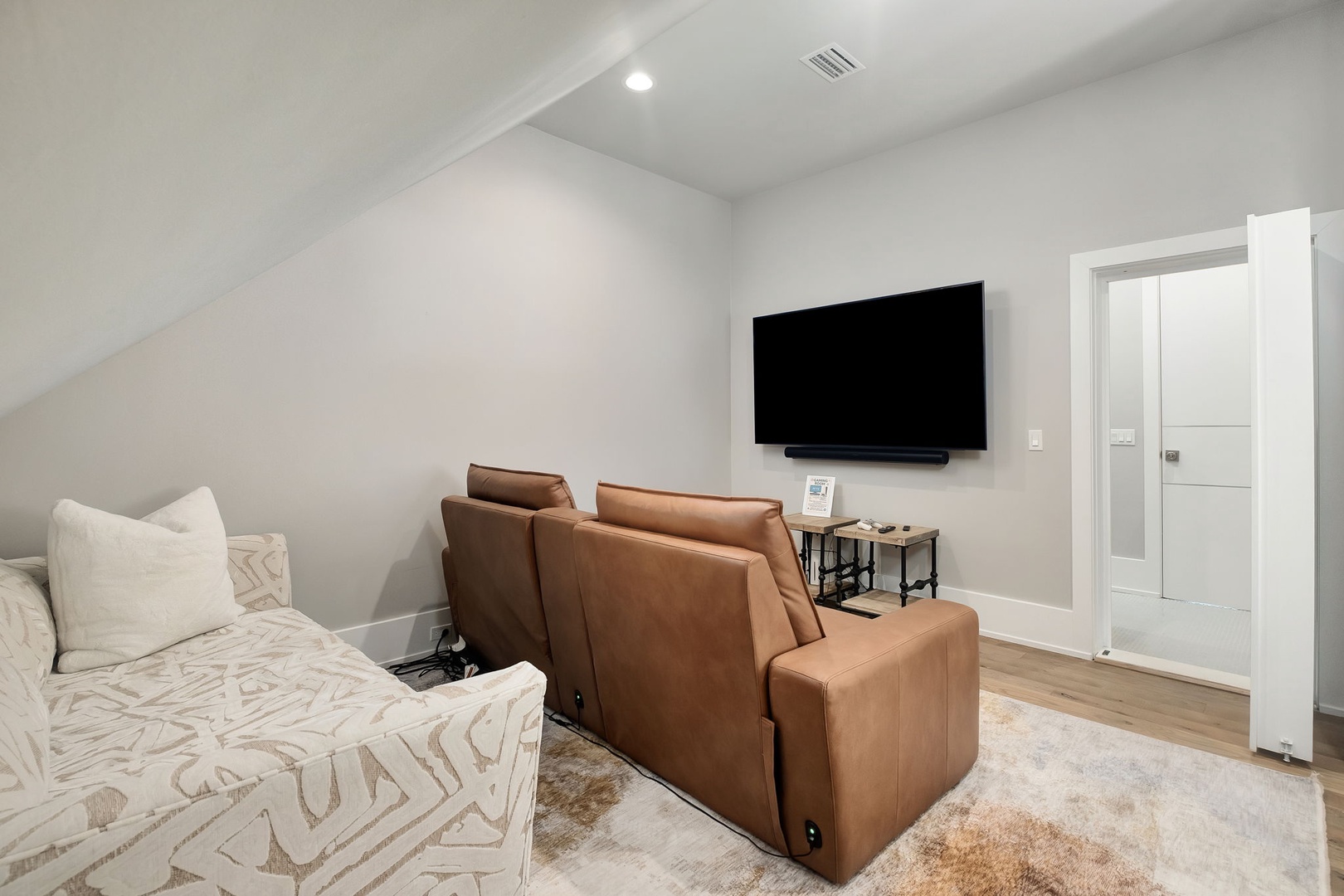 Relax in your private entertainment space with plush leather seating and large-screen TV for cozy movie nights.