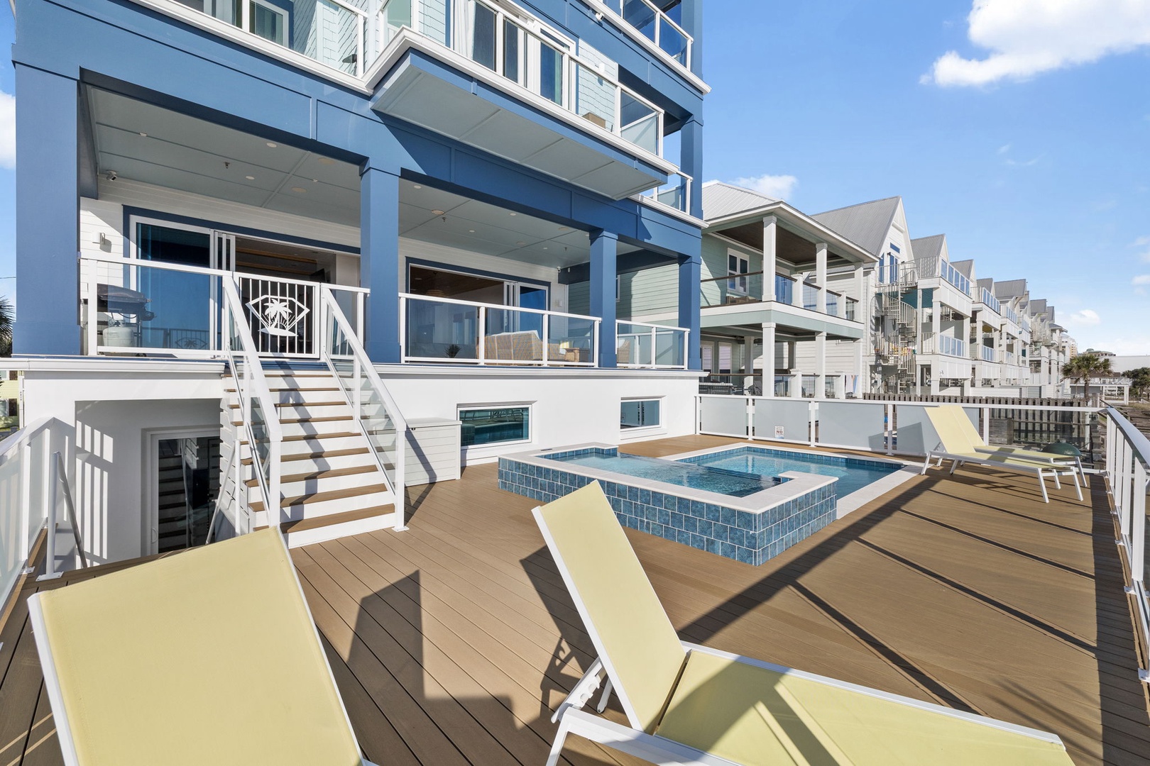 Stunning oceanfront property with private hot tub and deck loungers perfect for soaking up coastal sunshine.