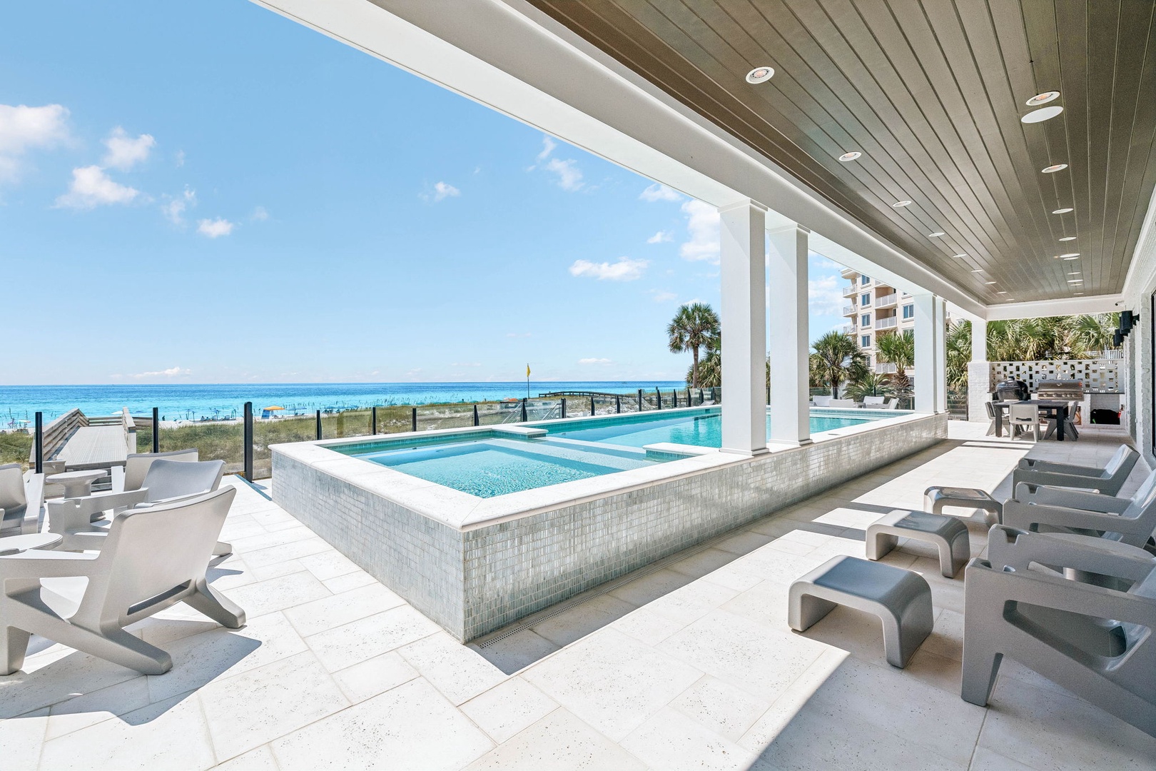 Step out onto your private poolside terrace, where turquoise waters and swaying palms frame an endless ocean horizon—your perfect spot to unwind under the Florida sun.