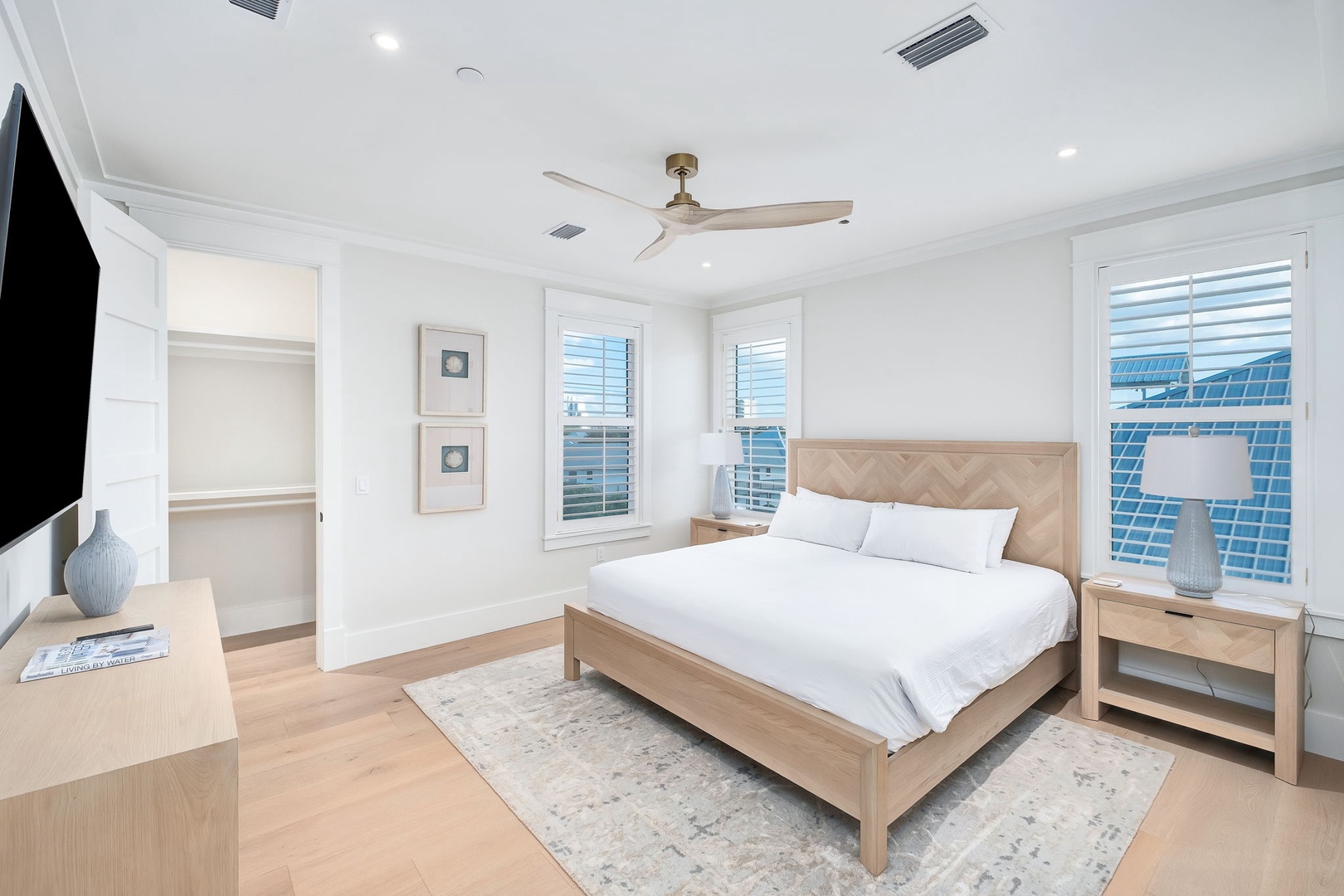 Your bright, airy bedroom awaits with crisp linens, natural wood tones, and abundant natural light—a peaceful retreat where you'll unwind after exploring the area.