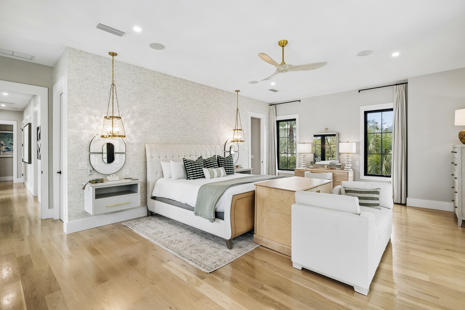 Step into your spacious suite where modern elegance meets coastal comfort. Sink into plush seating, unwind in your sumptuous bed, and enjoy your private workspace bathed in natural light.