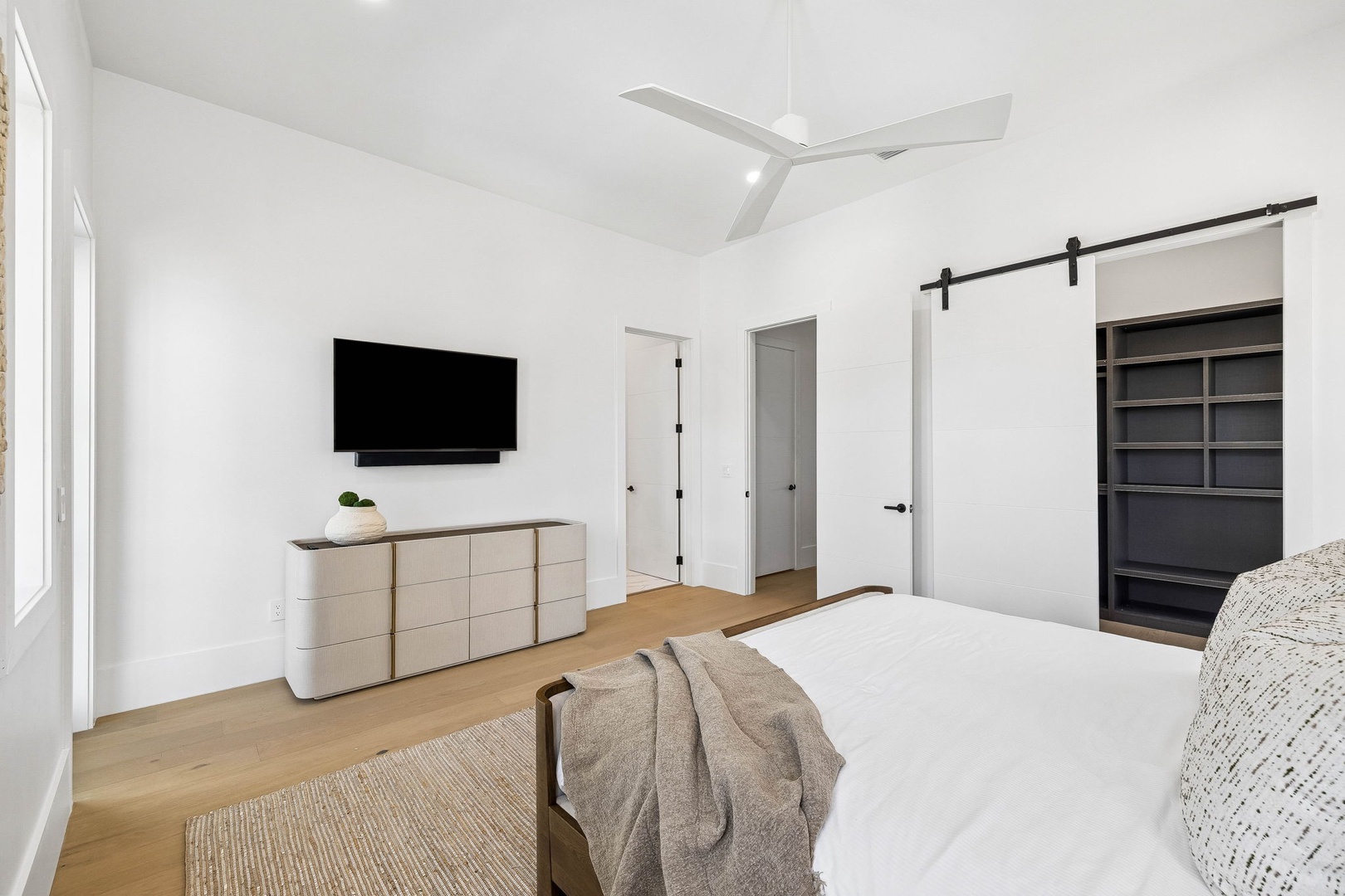 Your spacious bedroom blends modern comfort with serene simplicity—a calming retreat with vaulted ceilings, warm wood tones, and ample closet space for your belongings.