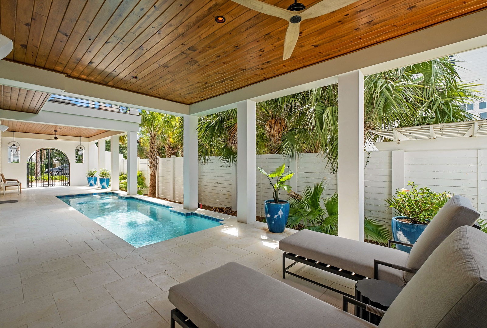 Escape to your own tropical oasis with a pristine pool framed by swaying palms and comfortable seating for ultimate relaxation.