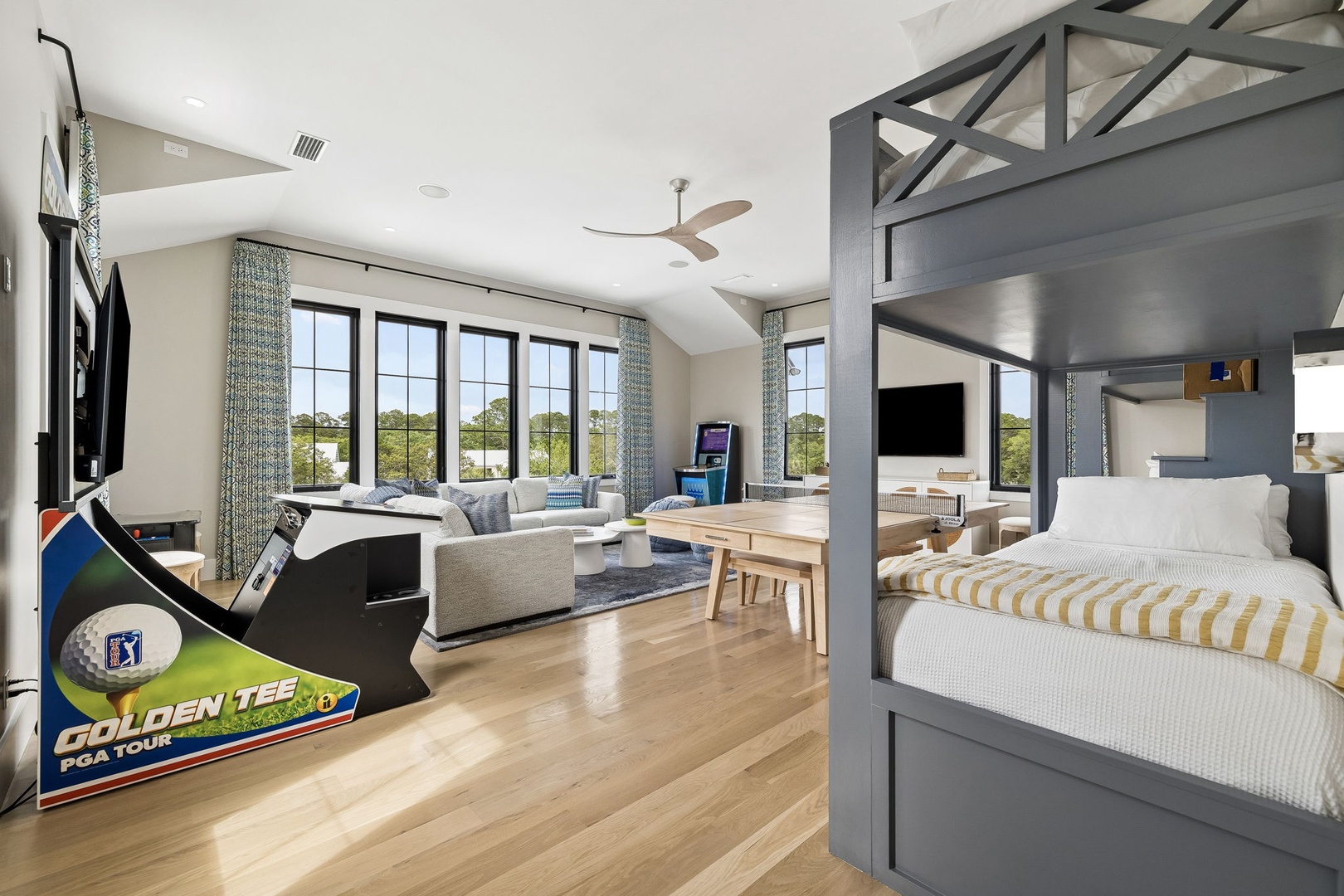 Step into your spacious open-concept retreat where sunlight pours through floor-to-ceiling windows, framing stunning lake views. Relax in the cozy living area, enjoy meals at the stylish dining table, or unwind on your plush bed—all in one beautifully des