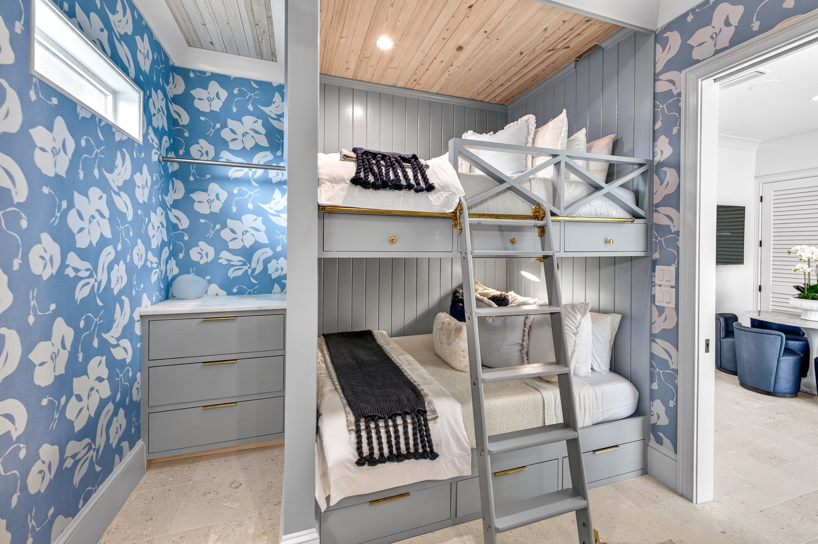 Drift off in your charming coastal bunk room, where blue florals and warm wood create the perfect seaside retreat for your group.