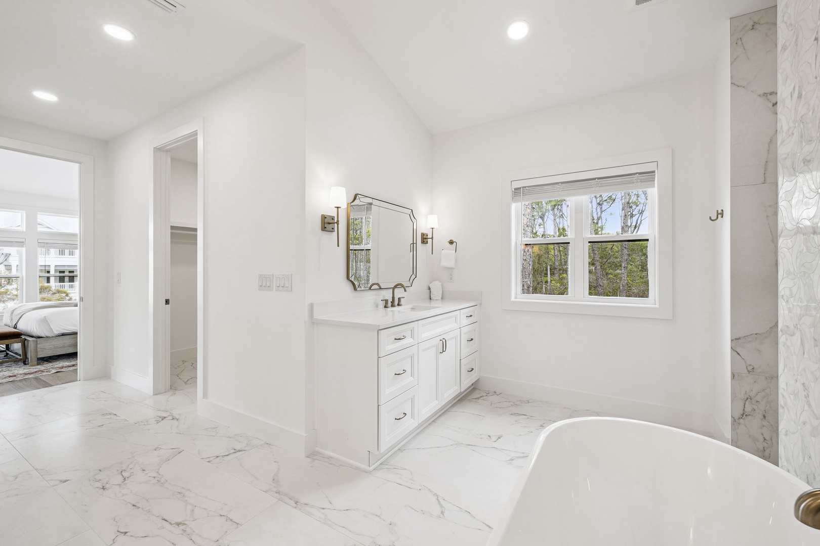 Luxurious marble bathroom with elegant soaking tub and double vanity awaits your peaceful retreat.