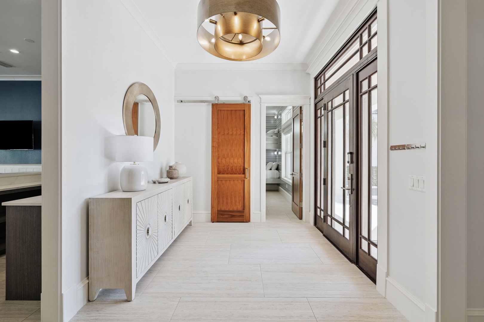 Step into your stylish entryway featuring warm wood accents, elegant lighting, and thoughtful design details that welcome you home.
