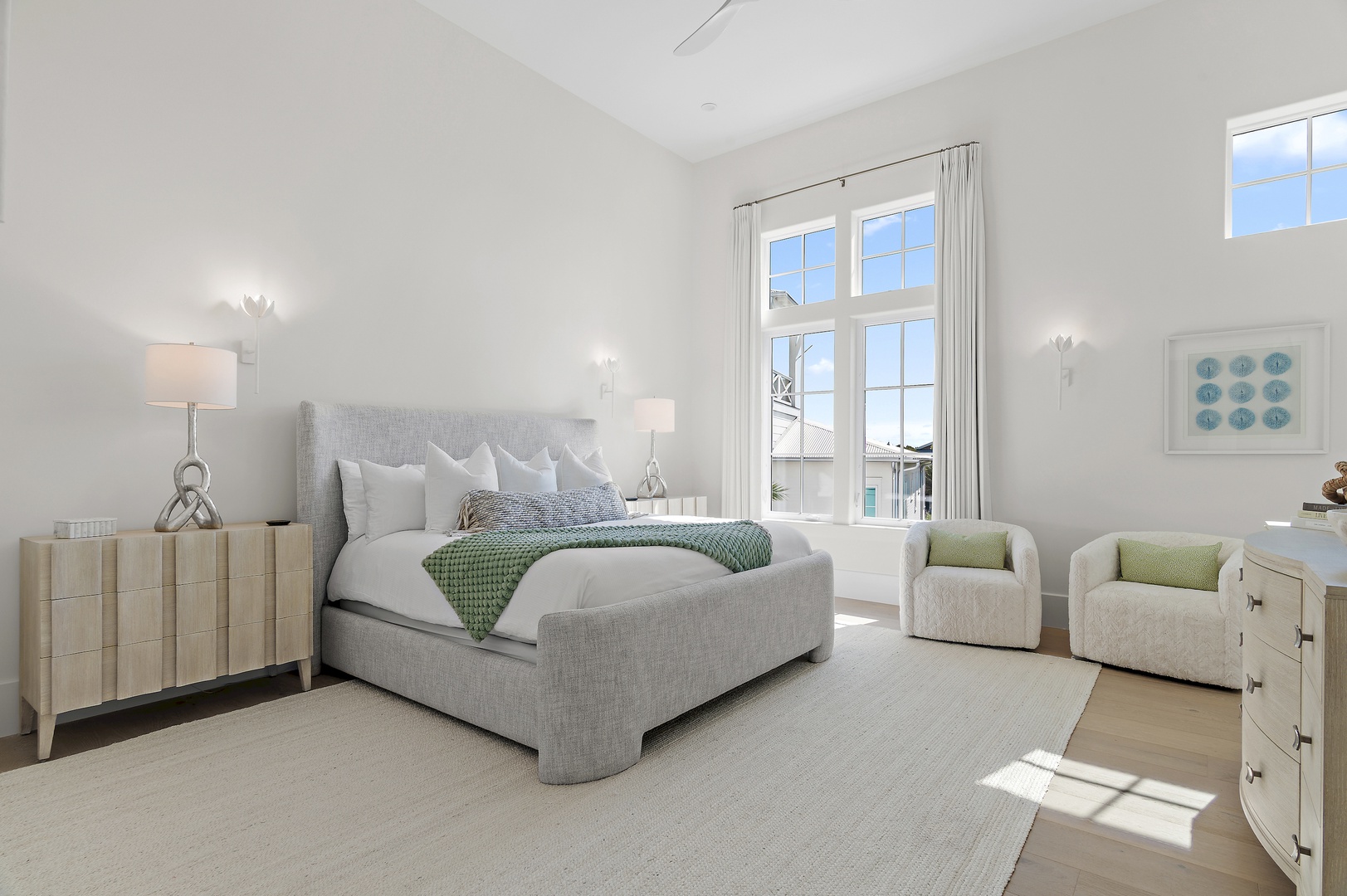 Sink into plush linens and let natural light fill your serene bedroom retreat, where calming coastal tones and a cozy reading nook invite pure relaxation.