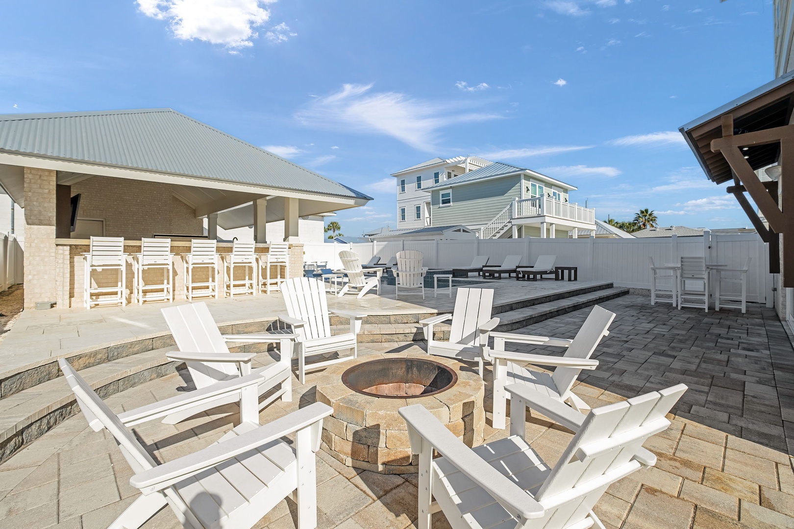 Gather around your private fire pit with classic Adirondack chairs, perfect for evening conversations under the open sky.