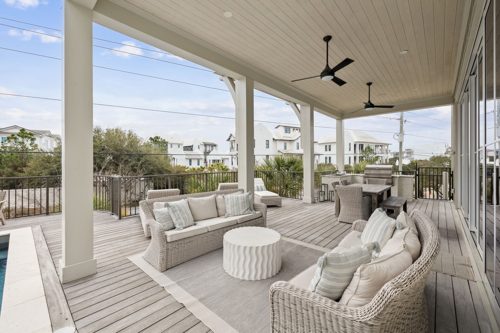 Unwind on your private covered deck with plush seating, ceiling fans, and dining space overlooking the neighborhood.