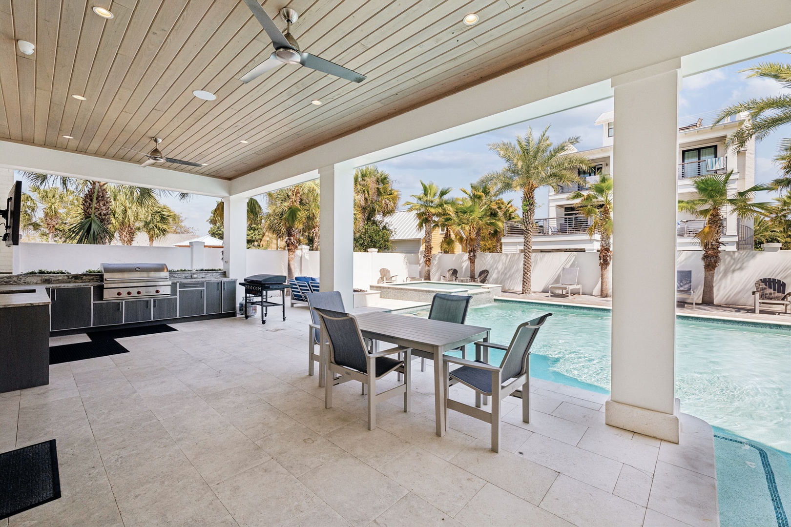 Dine poolside in your own tropical paradise with a fully equipped outdoor kitchen and stunning pool views.