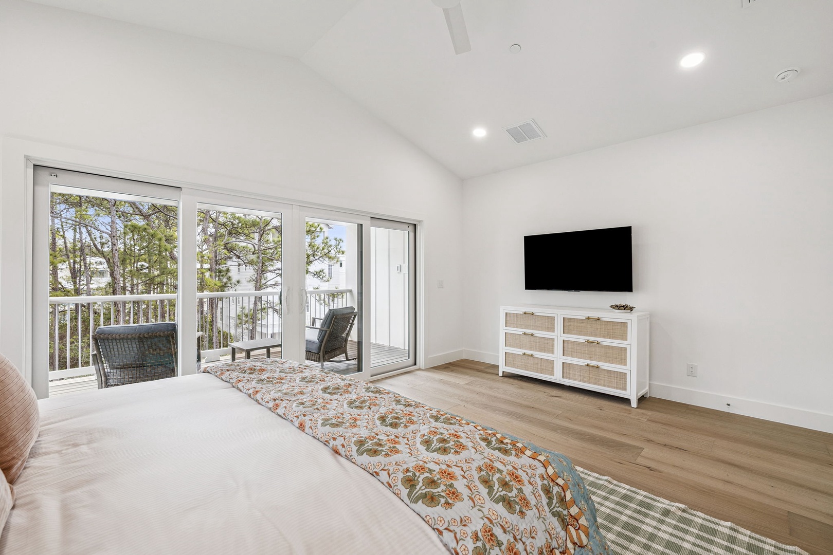 Your bright bedroom opens to a private balcony where morning coffee and peaceful tree views await your arrival.