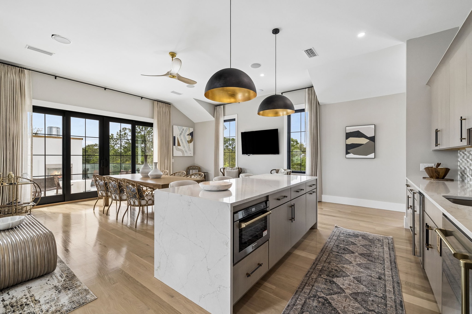 Your open-concept retreat features a chef's kitchen with a marble island, cozy dining space, and living area bathed in natural light from floor-to-ceiling windows opening to your private balcony.