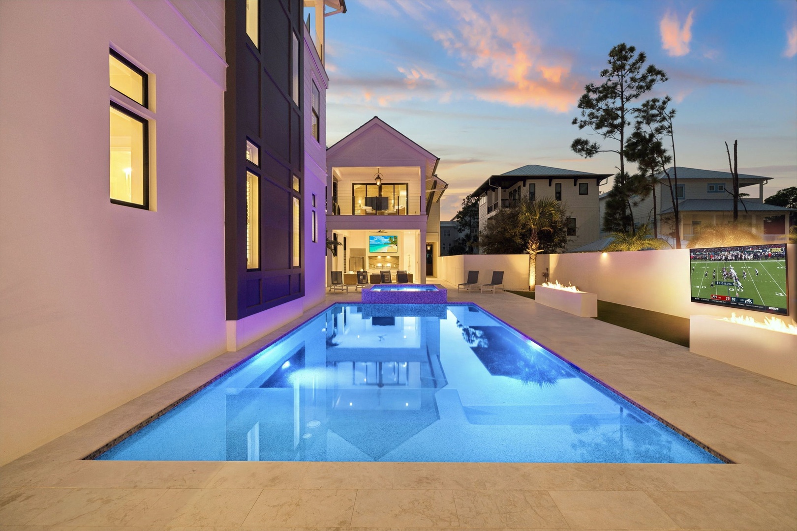 Modern outdoor retreat features a stunning pool illuminated at twilight. Enjoy warm evenings under soft lighting, with contemporary architecture framing the space. Perfect for unwinding after a day of adventure.
